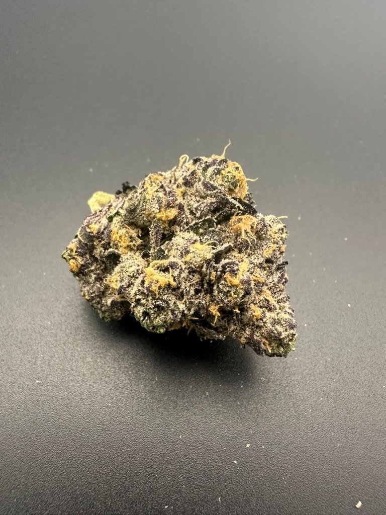 Closeup of harvested MI Flower cannabis on a dark surface